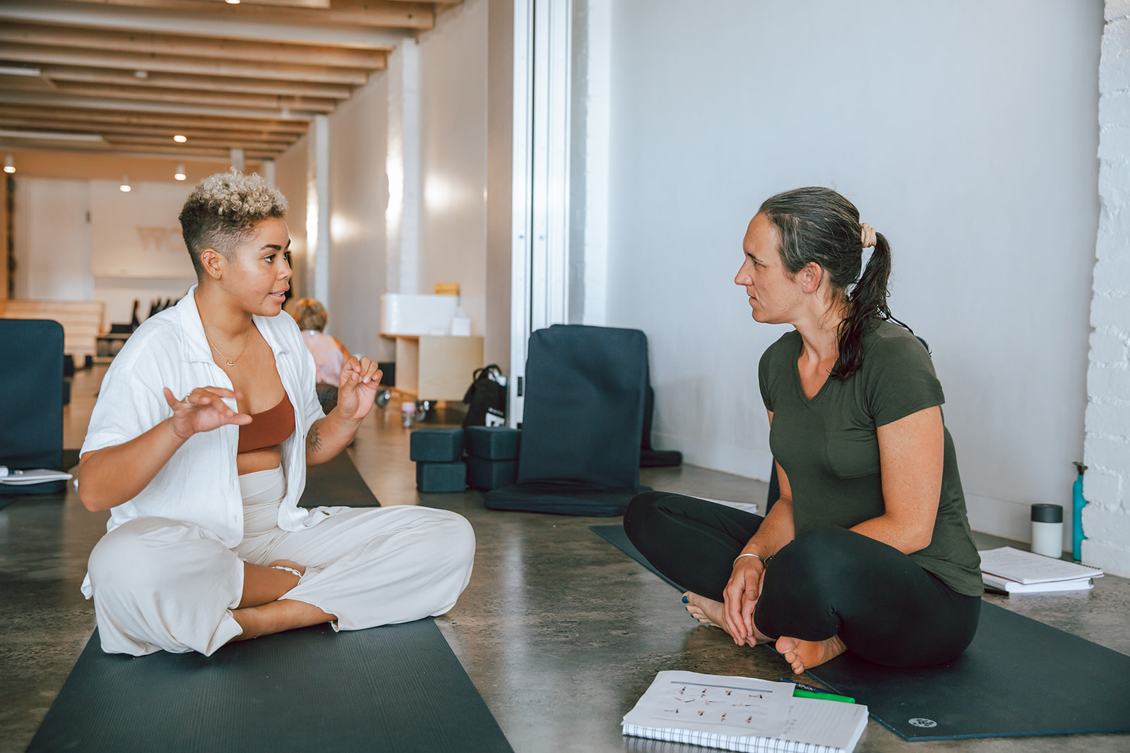 two students in seated discussion at warrior one yoga 200 hour vinyasa teacher training in mordialloc